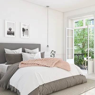 A bedroom with a large bed and a large window.