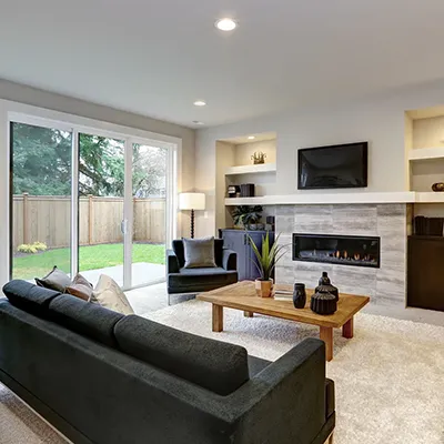 A living room filled with furniture and a fire place.