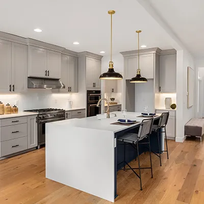 A large kitchen with a center island and a breakfast bar.